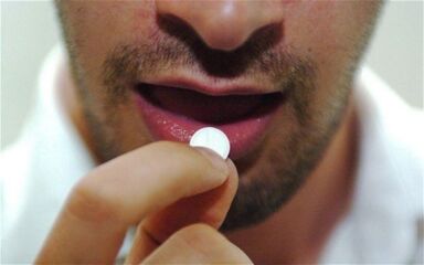 a person takes a pill to stimulate